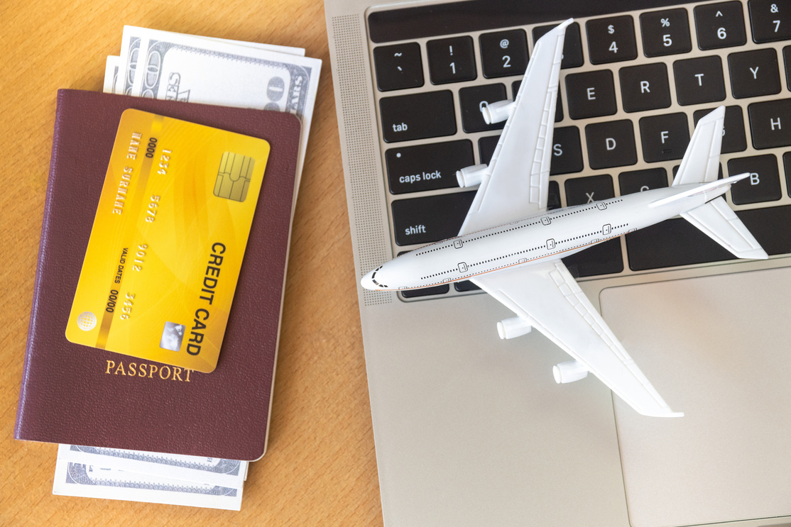 Air Tickets, Passports and Credit Card Near Laptop
