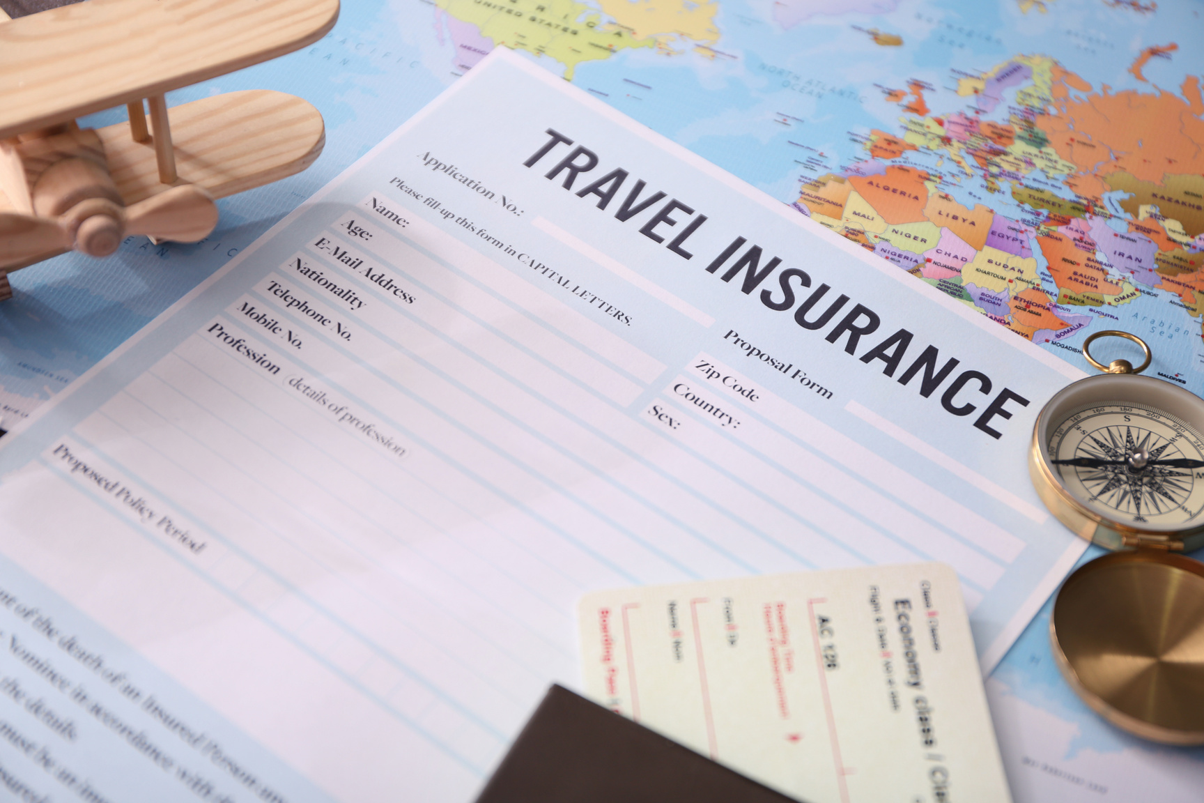 Blank Travel Insurance Form and Map on Background